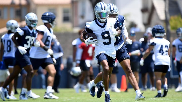 Cowboys receiver KaVontae Turpin runs with the ball after making a catch during training camp at River Ridge Fields in Oxnard.