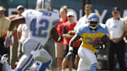 SEP 23, 2007; Philadelphia, PA, USA; Philadelphia Eagles running back Brian Westbrook (36) races Detroit Lions safety Gerald Alexander (42) to the end zone as he scores in the first quarter at Lincoln Financial Field in Philadelphia, PA. The Eagles are wearing blue and yellow throwback uniforms celebrating their 75th anniversary. Mandatory Credit: Howard Smith-Imagn Images Copyright © 2007 Howard Smith