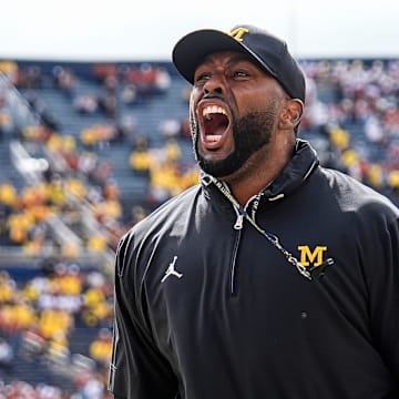 Michigan head coach Sherrone Moore cheer up the student section during warm up before the Texas game at Michigan Stadium in Ann Arbor on Saturday, September 7, 2024.