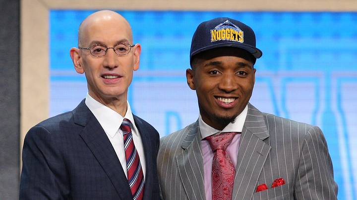 Jun 22, 2017; Brooklyn, NY, USA; Donovan Mitchell (Louisville) is introduced by NBA commissioner Adam Silver as the number thirteen overall pick to the Denver Nuggets in the first round of the 2017 NBA Draft at Barclays Center. Mandatory Credit: Brad Penner-Imagn Images