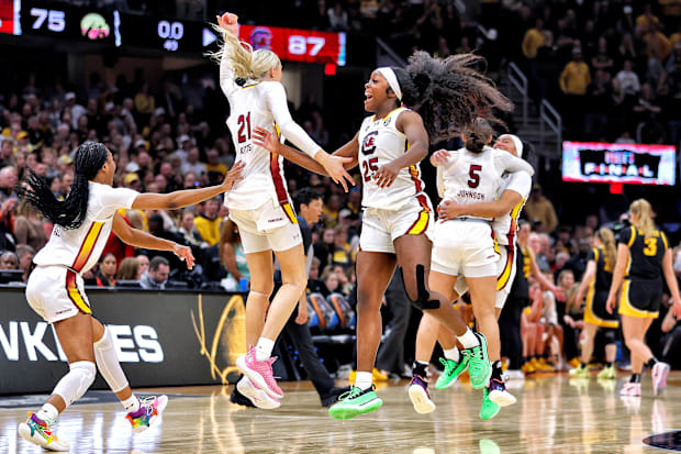 South Carolina basketball players celebrate on court after winning the 2023-24 national title. 