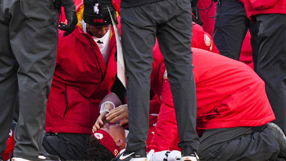 An injured Patrick Mahomes lays on the ground