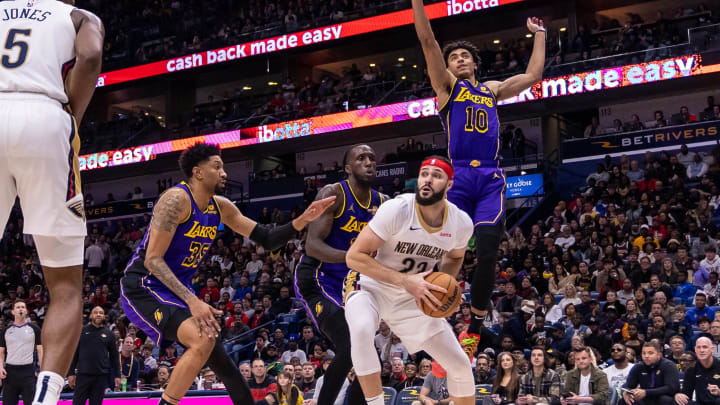 Dec 31, 2023; New Orleans, Louisiana, USA;  New Orleans Pelicans forward Larry Nance Jr. (22) looks to pass the ball against Los Angeles Lakers forward Christian Wood (35) and guard Max Christie (10) during the second half at Smoothie King Center. Mandatory Credit: Stephen Lew-USA TODAY Sports