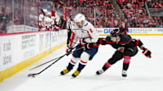 May 10, 2025; Raleigh, North Carolina, USA; Washington Capitals left wing Alex Ovechkin (8) skates with the puck outside of Carolina Hurricanes defenseman Dmitry Orlov (7) during the second period in game three of the second round of the 2025 Stanley Cup Playoffs at Lenovo Center. Mandatory Credit: James Guillory-Imagn Images
