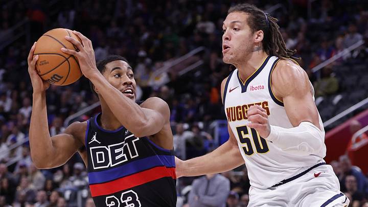 Nov 20, 2023; Detroit, Michigan, USA;  Detroit Pistons guard Jaden Ivey (23) is defended by Denver Nuggets forward Aaron Gordon (50): Rick Osentoski-Imagn Images
