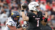 Houston Cougars quarterback Conner Weigman drops back to pass against the West Virginia Mountaineers in the first half at TDECU Stadium