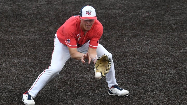 Liberty's Will Wagner (17) stops a ground ball during the NCAA baseball regional final between