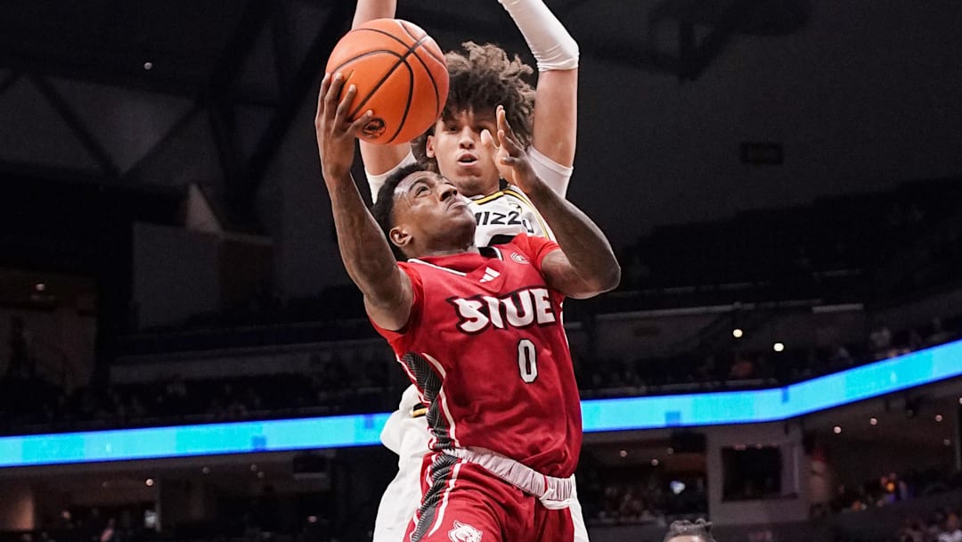 Nov 13, 2023; Columbia, Missouri, USA; SIU Edwardsville Cougars guard Damarco Minor (0) shoots a layup as Missouri Tigers forward Jordan Butler (0) defends during the second half at Mizzou Arena. Mandatory Credit: Denny Medley-Imagn Images