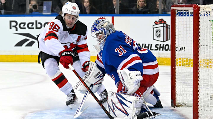 Dec 2, 2024; New York, New York, USA;  New York Rangers goaltender Igor Shesterkin (31) makes a save on New Jersey Devils center Jack Hughes (86) during the first period at Madison Square Garden. Mandatory Credit: Dennis Schneidler-Imagn Images
