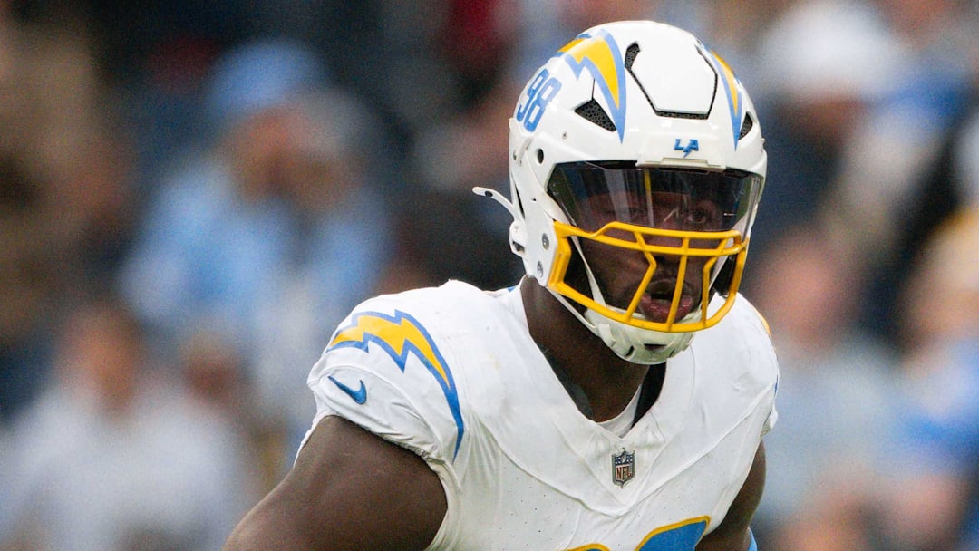 Nov 2, 2025; Nashville, Tennessee, USA;  Los Angeles Chargers linebacker Odafe Oweh (98) celebrates his sack with linebacker Tuli Tuipulotu (45) against the Tennessee Titans during the second half at Nissan Stadium. Mandatory Credit: Steve Roberts-Imagn Images