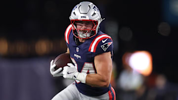 Aug 8, 2025; Foxborough, Massachusetts, USA; New England Patriots running back Lan Larison (34) runs the ball during the second half against the Washington Commanders at Gillette Stadium. Mandatory Credit: Paul Rutherford-Imagn Images