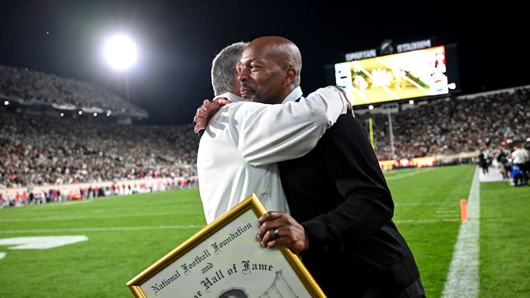 Former Michigan State head coach Mark Dantonio, left, hugs athletic director Alan Haller after Dantonio was recognized for his induction to the National Football Foundation Hall of Fame and for his addition to the the Spartans Ring of Fame during MSU's game against Ohio State on Saturday, Sept. 28, 2024, at Spartan Stadium in East Lansing.