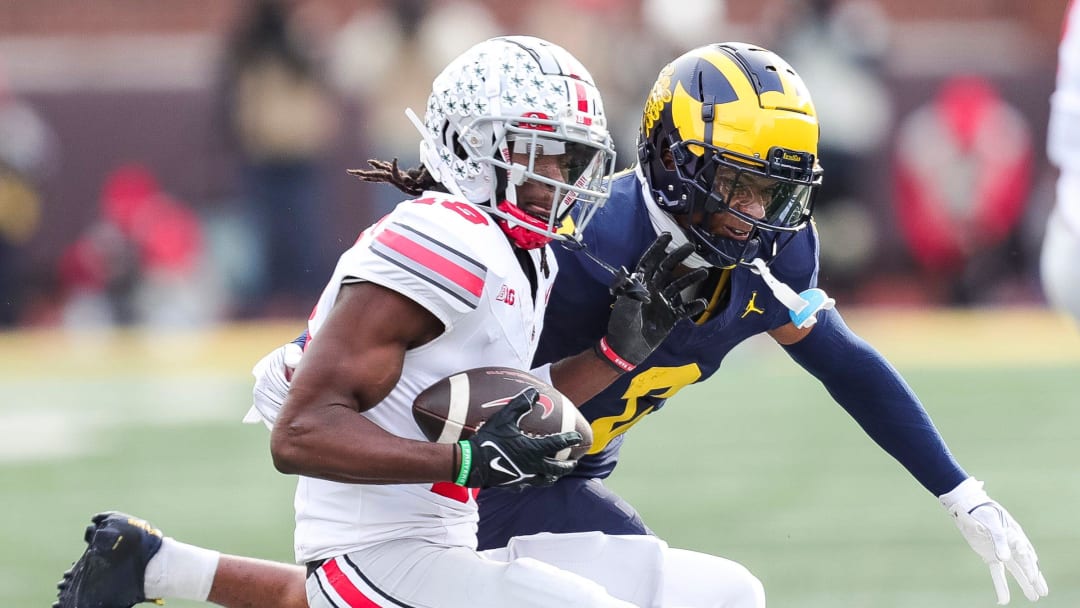 Michigan defensive back Will Johnson defends Ohio State receiver Marvin Harrison Jr. during the second half at Michigan Stadium in Ann Arbor on Saturday, Nov. 25, 2023.