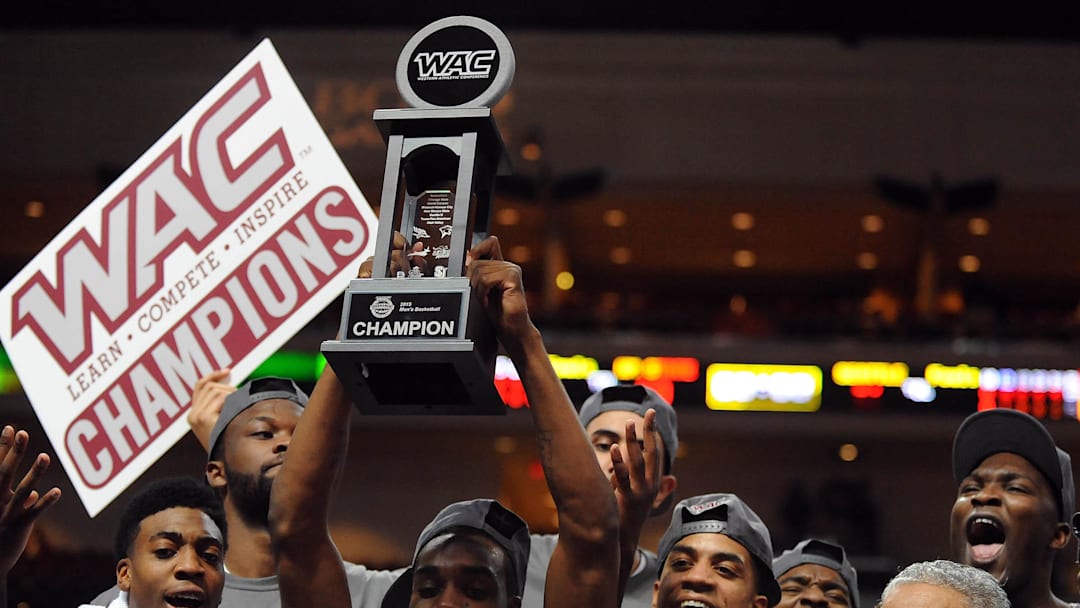 Mar 14, 2015; Las Vegas, NV, USA; New Mexico Aggies players celebrate after defeating Seattle 80-61 to claim the Western Athletic Conference Tournament title at Orleans Arena. Mandatory Credit: Stephen R. Sylvanie-Imagn Images