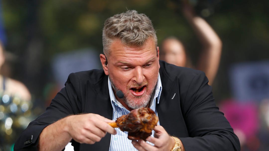 ESPN's Pat McAfee goes to eat the lamb provided by Fiddler Hearth during \"College GameDay\" Saturday at Notre Dame.