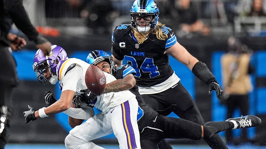 Detroit Lions cornerback Kindle Vildor forces Minnesota Vikings wide receiver Justin Jefferson to drop the pass as linebacker Alex Anzalone closes in during the second half at Ford Field in Detroit on Sunday, Jan. 5, 2025.
