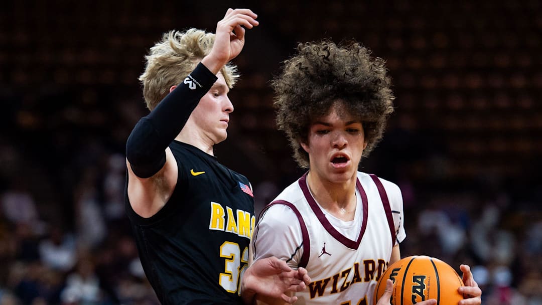 Windsor's Thales Price drives through Rams player Ben Swanson(32) during the Colorado Class 5A boys basketball state title game against Green Mountain on Saturday, March 15, 2025 at the Denver Coliseum in Denver, Colo.