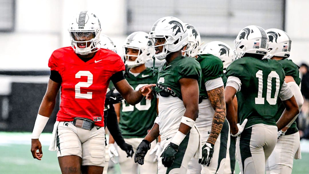 Michigan State quarterback Aidan Chiles, left, talks with Nick Marsh during a break in football practice on Tuesday, April 8, 2025, in East Lansing.