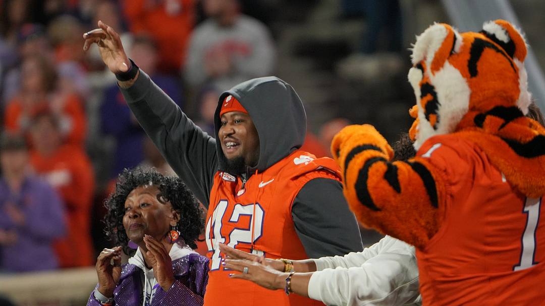 Clemson defensive tackle Hevin Brown-Shuler (42) waves to fans near family as the announcer tells the crowd he rang a bell for his last cancer treatment last Thursday, during a break in the first quarter with Virginia Tech Hokies at Memorial Stadium Saturday, October 24, 2026.