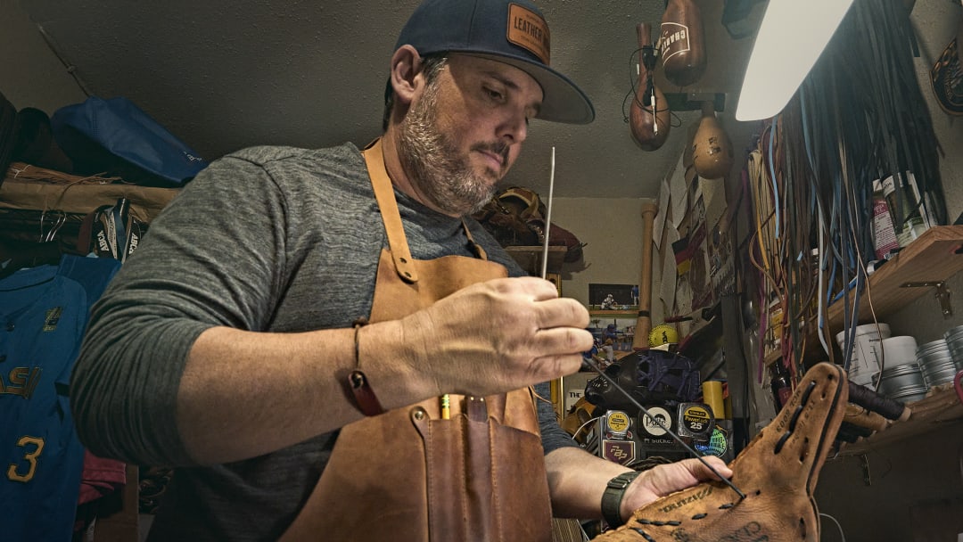 Petroff applies exacting standards to his glove repair.