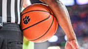 A referee holds a ball with a Clemson logo in a time out period during the first half at Littlejohn Coliseum Tuesday, Feb 8, 2022.