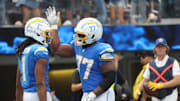 Sep 21, 2025; Inglewood, California, USA; Los Angeles Chargers wide receiver Quentin Johnston (1) and Los Angeles Chargers guard Zion Johnson (77) react after a play during the first half against the Denver Broncos at SoFi Stadium. Mandatory Credit: William Navarro-Imagn Images