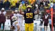 Michigan defensive lineman Mason Graham celebrates after sacking Minnesota quarterback Max Brosmer, in the background, during first-half action between Michigan and Minnesota at Michigan Stadium in Ann Arbor on Saturday, Sept. 28, 2024.