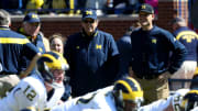 April 4, 2015: Gary Moeller and Lloyd Carr join Jim Harbaugh in watching Michigan football practice.