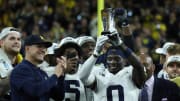 Michigan coach Jim Harbaugh celebrates defensive back Mike Sainristil (0), who was named MVP, after U-M's 26-0 win over Iowa in the Big Ten championship game on Saturday, Dec. 2, 2023, in Indianapolis.