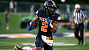 Haslett's Kory Amachree runs for a touchdown against DeWitt during the second quarter on Thursday, Aug. 29, 2024, at Haslett High School.