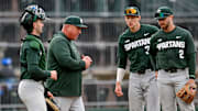 Michigan State's head coach Jake Boss Jr., center, talks to the team during a pitching change in the second inning on Wednesday, April 3, 2024, during the Crosstown Showdown against the Lugnuts at Jackson Field in Lansing.