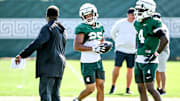 Michigan State's Jace Clarizio, center, listens to coaches after a drill during football practice on Monday, Aug. 11, 2025, in East Lansing.