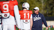 Auburn Tigers head coach Hugh Freeze works with new quarterback Jackson Arnold at spring practice.