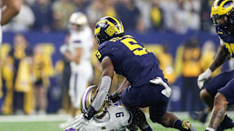 Michigan defensive end Josaiah Stewart tackles Washington quarterback Michael Penix Jr. during the first half of the national championship game at NRG Stadium in Houston, Texas on Monday, Jan. 8, 2024.