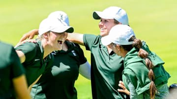 Michigan State's Leila Raines, center, celebrates with teammates after finishing the final round of