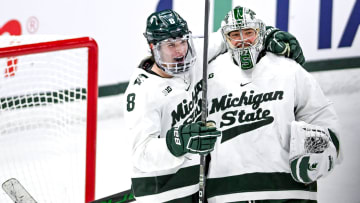 Michigan State's Maxim Strbak, left, and goalie Trey Augustine celebrate after bearing Ohio State in the Big Ten tournament game on Saturday, March 16, 2024, at Munn Arena in East Lansing.