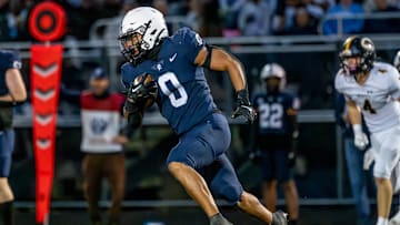 East Lansing's Jace Clarizio runs for a gain against DeWitt during the second quarter on Friday, Sept. 27, 2024, at East Lansing High School.