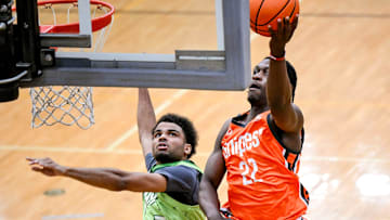 Team Snipes and Michigan State's Trey Fort, right, scores as Team Faygo's Darrius Welch defends during the Moneyball Pro-Am on Thursday, June 26, 2025, at Holt High School.