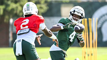 Michigan State running back Elijah Tau-Tolliver, right, gets a pitch from Aidan Chiles during football practice on Monday, Aug. 11, 2025, in East Lansing.