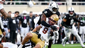 Michigan State's Anelu Lafaele, bottom, and Jalen Thompson, top, tackle Boston College's Dylan Lonergan during the first quarter on Saturday, Sept. 6, 2025, at Spartan Stadium in East Lansing.