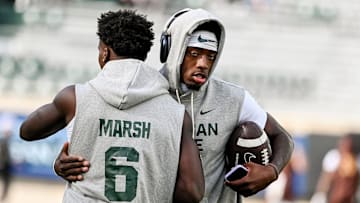 Michigan State's quarterback Aidan Chiles, right, hugs Nick Marsh before the football game against Western Michigan on Friday, Aug. 29, 2025, in East Lansing.