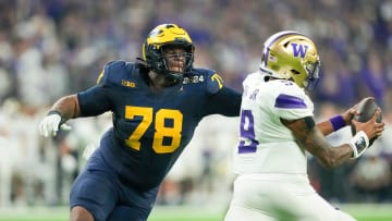 Michigan defensive lineman Kenneth Grant (78) reaches out to sack Washington quarterback Michael Penix Jr. (9) in the second quarter during the College Football Playoff national championship game against Washington at NRG Stadium in Houston, Texas on Monday, January 8, 2024.