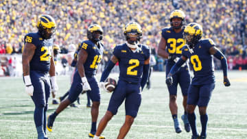 Michigan defensive back Will Johnson celebrates after intercepting a pass from Ohio State quarterback Kyle McCord during the first half at Michigan Stadium in Ann Arbor on Saturday, Nov. 25, 2023.