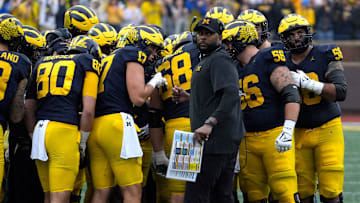 Michigan football coach Sherrone Moore looks at the ref during a time out during first-half action between Michigan and Minnesota at Michigan Stadium in Ann Arbor on Saturday, Sept. 28, 2024.