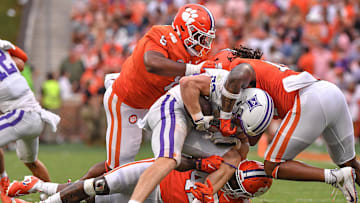 Clemson defensive tackle Tre Williams (8), linebacker Kevin Swint (14), and linebacker LaVonta Bentley (42) tackle Furman Paladins tight end Ryan Miller (82) during the fourth quarter at Memorial Stadium in Clemson, South Carolina Saturday, September 10, 2022.