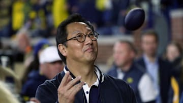 Michigan president Santa Ono throws footballs to fans during during the second half of Michigan's 41-13 win on Saturday, Nov 4, 2023, in Ann Arbor.