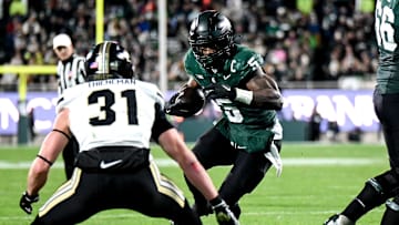 Dillon Thieneman squares up on Michigan State running back Nathan Carter in a game in East Lansing last November. He's already emerging as a leader on the 2025 Oregon defense.