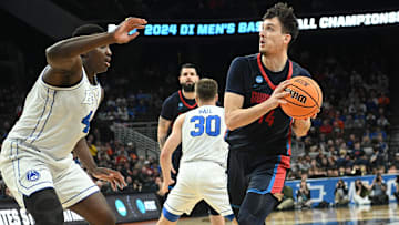 Mar 21, 2024; Omaha, NE, USA; Duquesne Dukes forward Matus Hronsky (14) drives against Brigham Young Cougars forward Fousseyni Traore (45) in the first half during the first round of the NCAA Tournament at CHI Health Center Omaha. Mandatory Credit: Steven Branscombe-Imagn Images