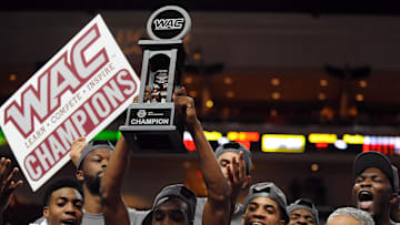 Mar 14, 2015; Las Vegas, NV, USA; New Mexico Aggies players celebrate after defeating Seattle 80-61 to claim the Western Athletic Conference Tournament title at Orleans Arena. Mandatory Credit: Stephen R. Sylvanie-Imagn Images