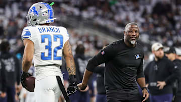 Detroit Lions defensive coordinator Aaron Glenn shakes hands with safety Brian Branch before the Dallas Cowboys game at AT&T Stadium in Arlington, Texas on Saturday, Dec. 30, 2023.